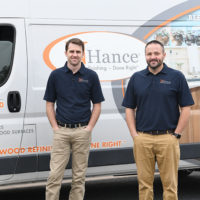 N-Hance wood franchise franchisees stand in front of van